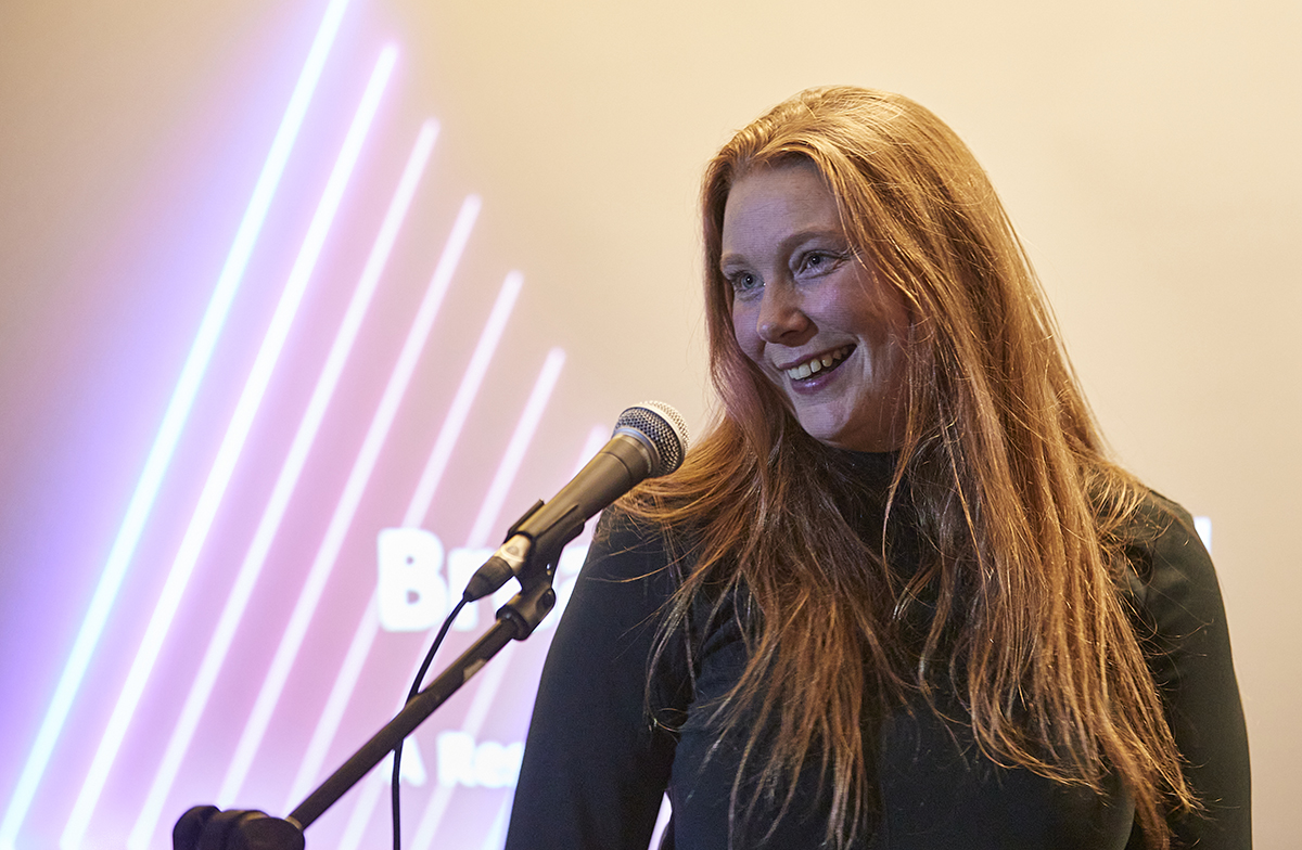 A researcher singing into a microphone