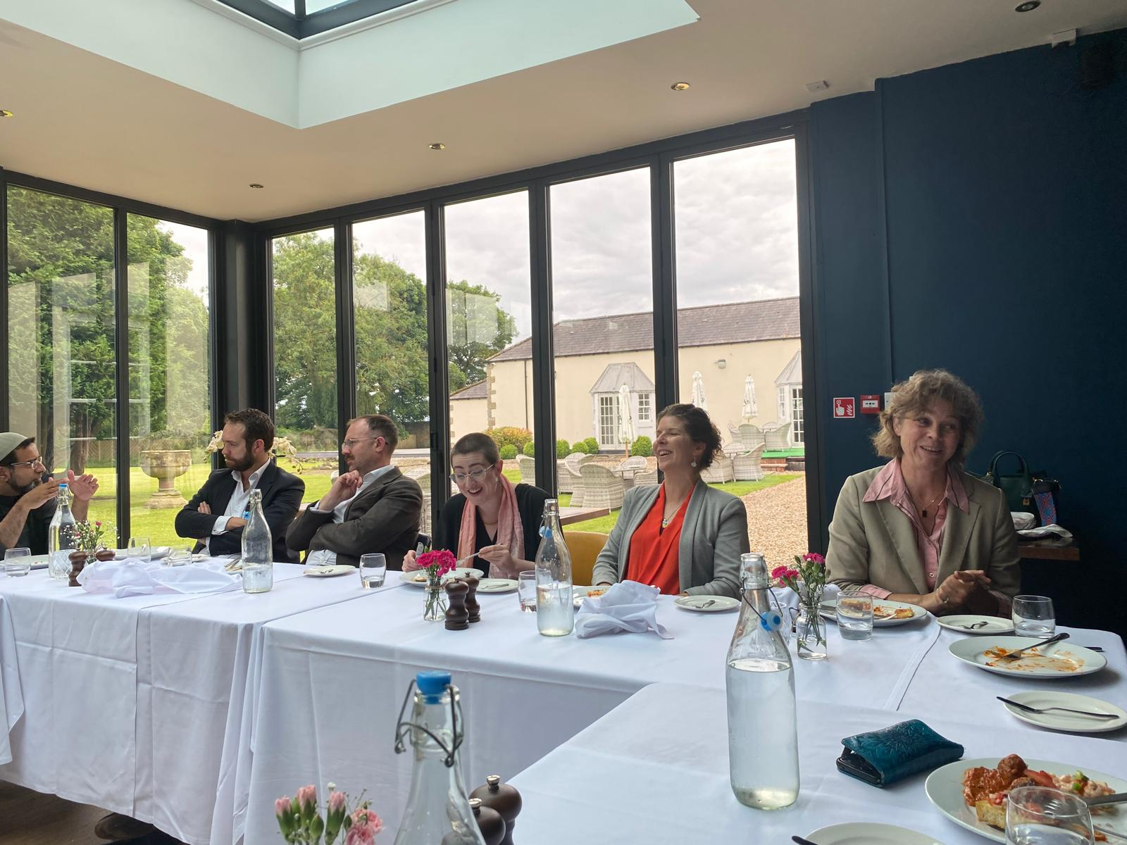 advisory board members sitting around a table eating lunch and having so much fun