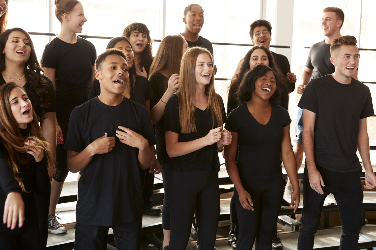 Male And Female Students Singing In Choir
