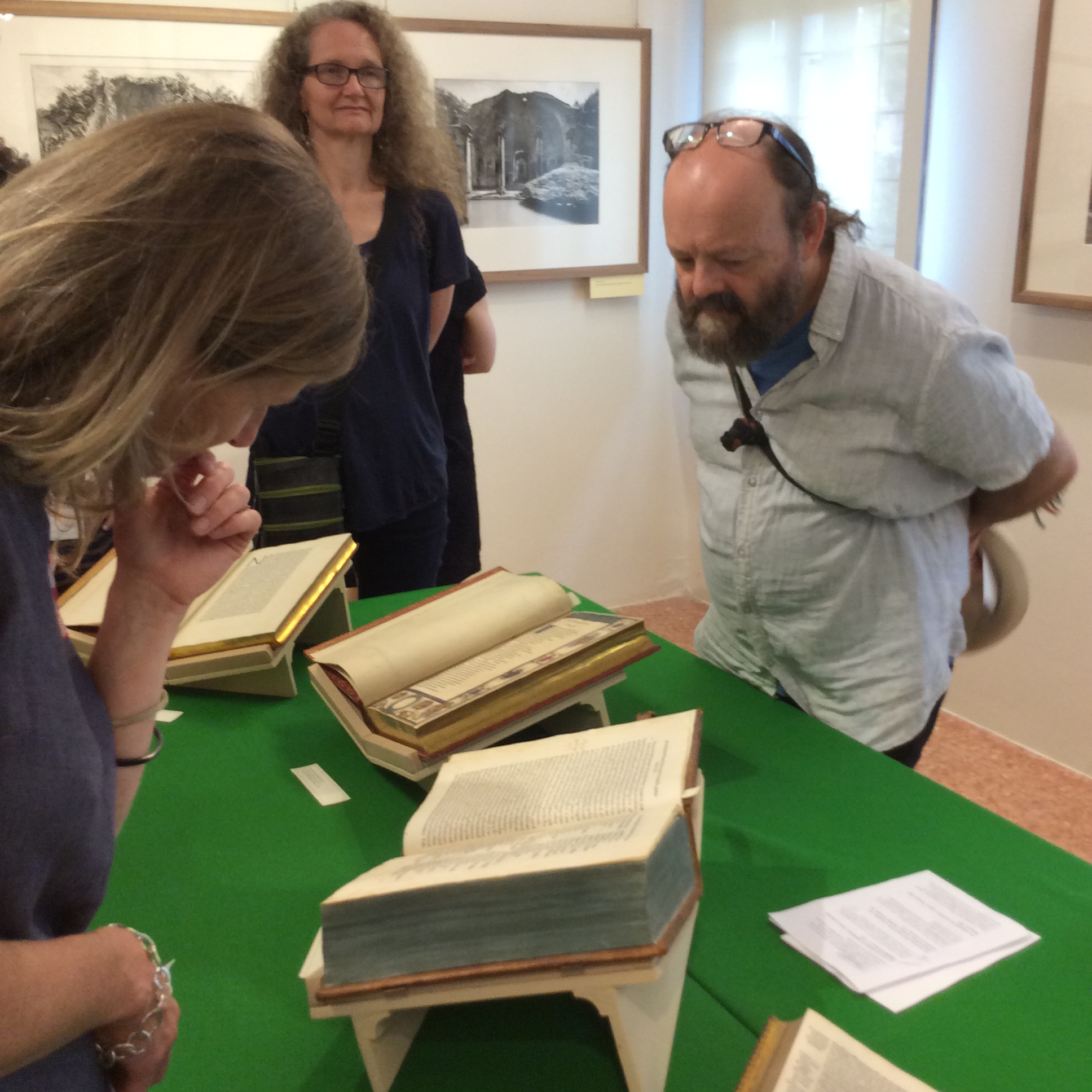 Three researchers looking at a manuscript