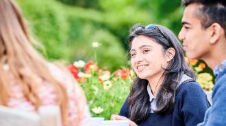 TStudents at a table in the botanic garden