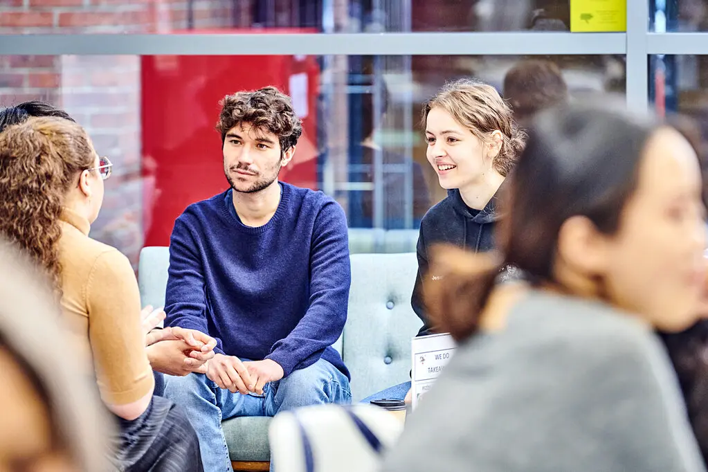 A group of students sitting talking in a communal area in Ustinov College