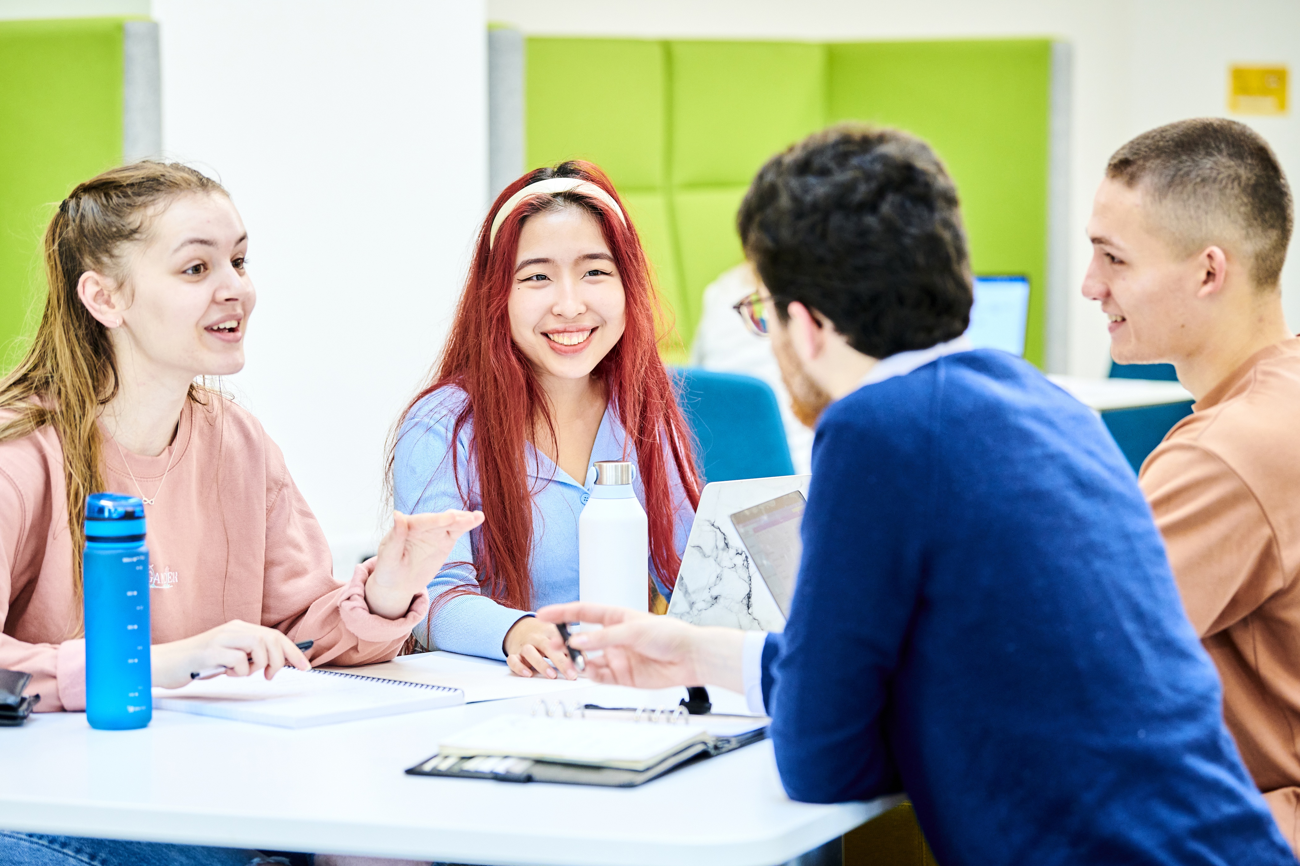 Students chatting and studying in the Teaching and Learning Centre.