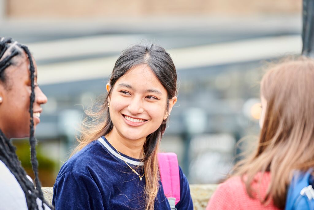 Three female students, one facing the camera