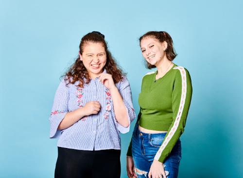 Two students on blue background