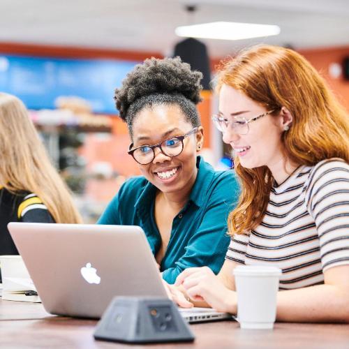 Students working on laptop in Bill Bryson Library café